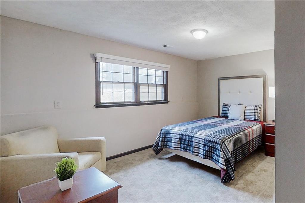 2284 Emerald Springs Drive Decatur, GA 30035 - Photo 21 of 30 a bedroom with a bed and a couch