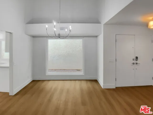 a view of room with wooden floor