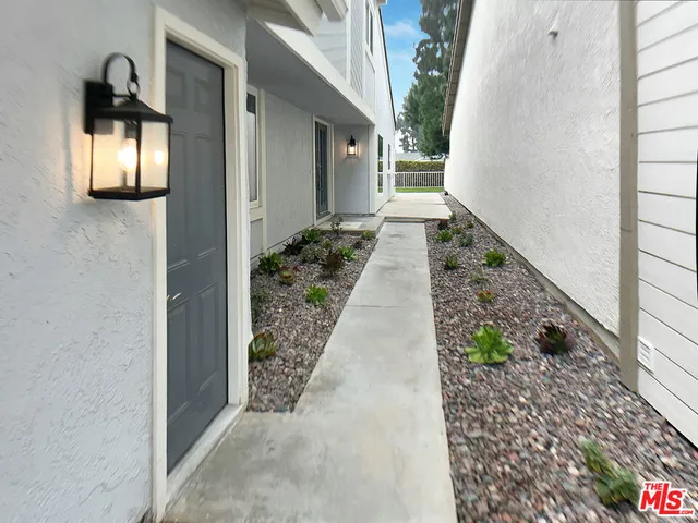 a view of a pathway besides a house