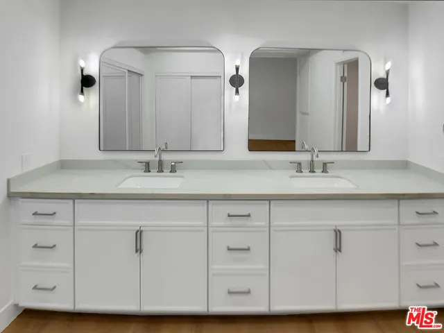 a bathroom with a sink vanity and a mirror