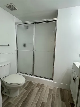 a bathroom with a toilet and a shower