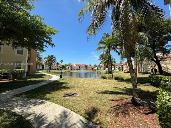 a view of a lake with palm trees