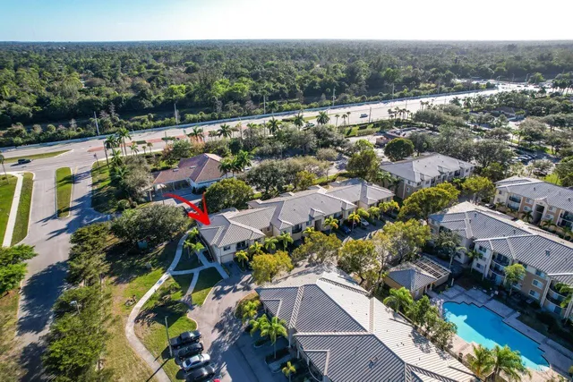 an aerial view of a houses with a yard