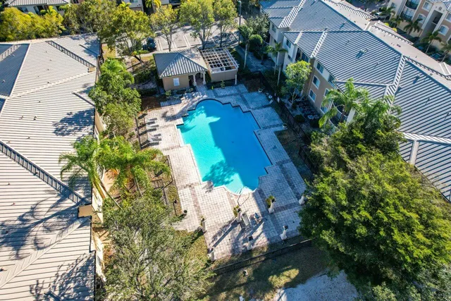an aerial view of a house with a yard