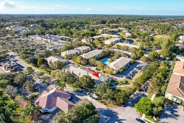 an aerial view of residential houses with outdoor space and trees