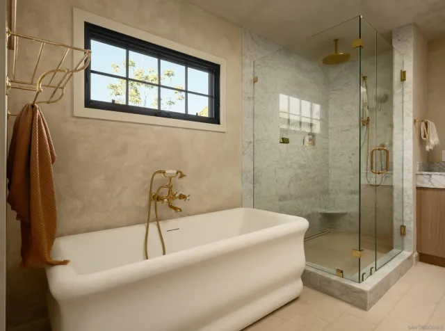 a bathroom with a granite countertop sink mirror toilet and bathtub