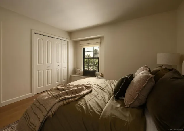 a bedroom with a bed and a window