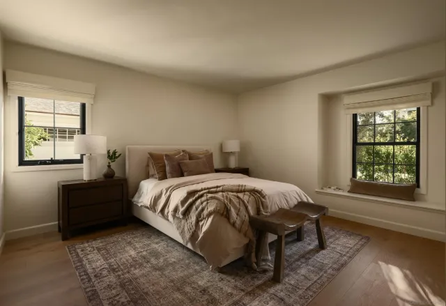 a bed sitting in a bedroom next to a window