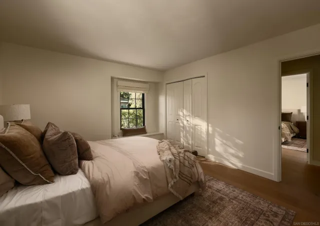 a bathroom with a granite countertop sink a toilet and a mirror
