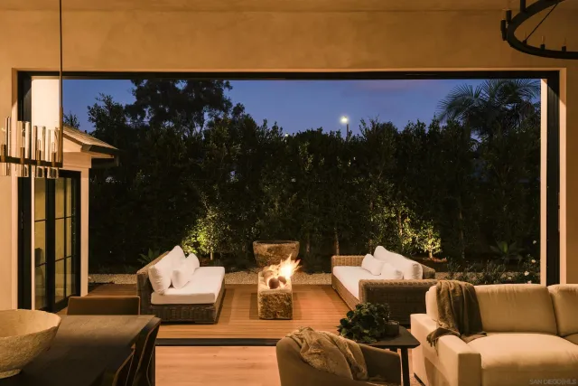 a view of a chairs and table in a backyard