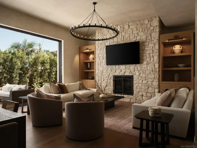 a living room with furniture a flat screen tv and a fireplace