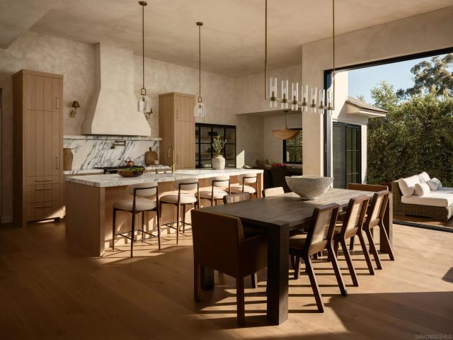 a view of a dining room and livingroom with furniture wooden floor a chandelier