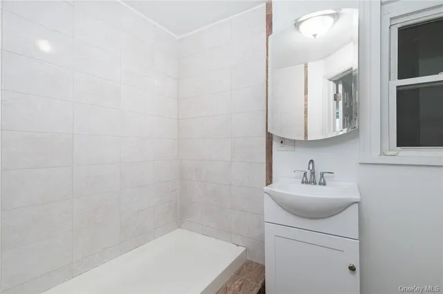 a bathroom with a sink a toilet and mirror