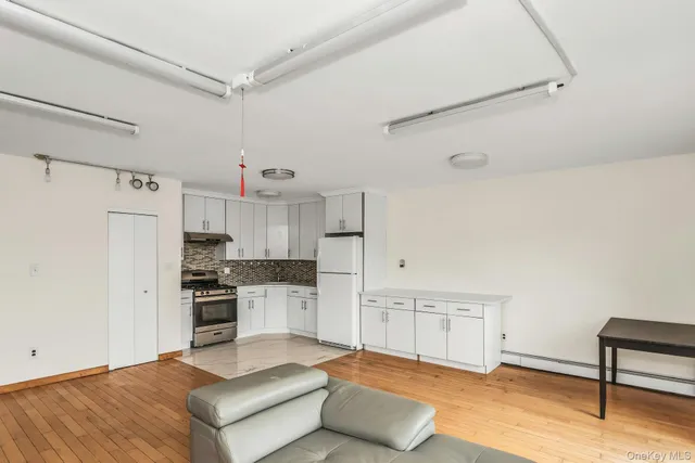 a kitchen with stainless steel appliances kitchen island granite countertop a refrigerator and a stove top oven