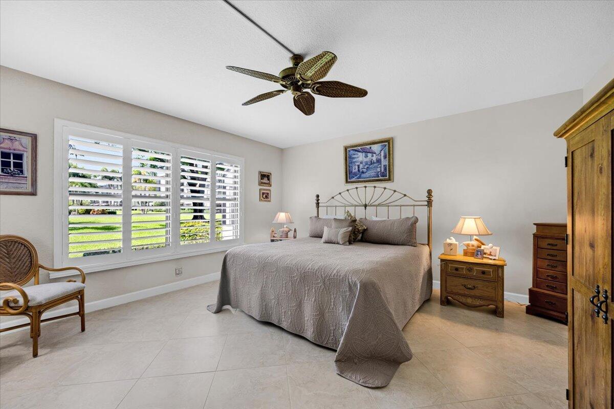 300 North Hwy A1A, Unit 104O Jupiter, FL 33477 - Photo 13 of 25 a spacious bedroom with a bed and a window
