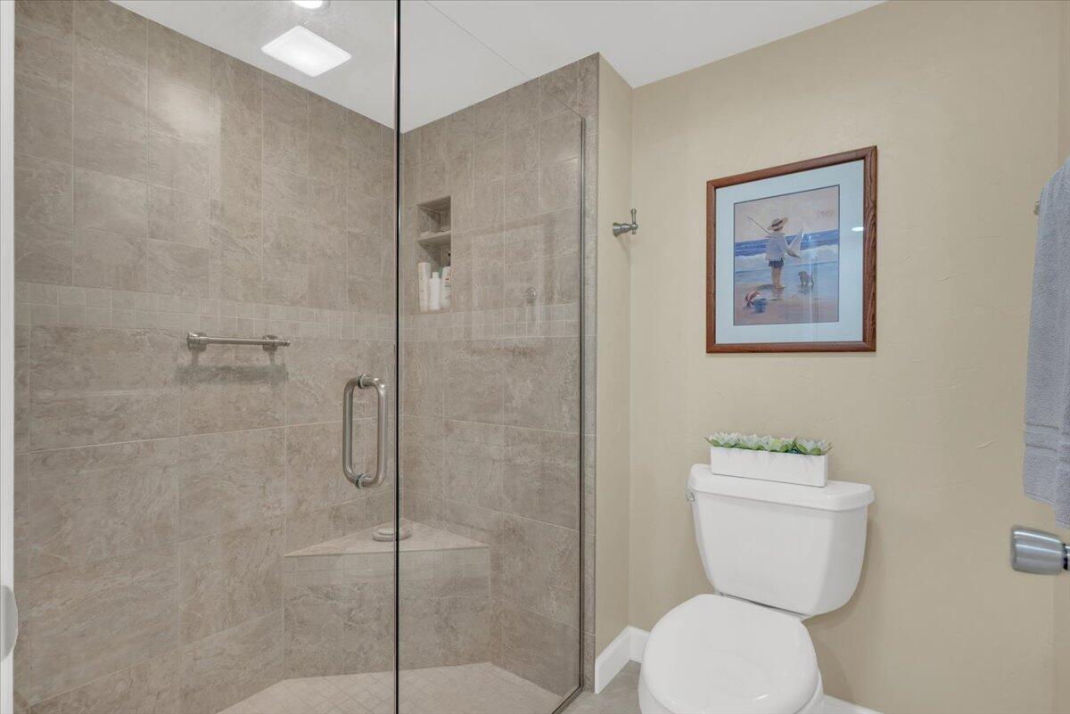 300 North Hwy A1A, Unit 104O Jupiter, FL 33477 - Photo 15 of 25 a bathroom with a toilet and a shower