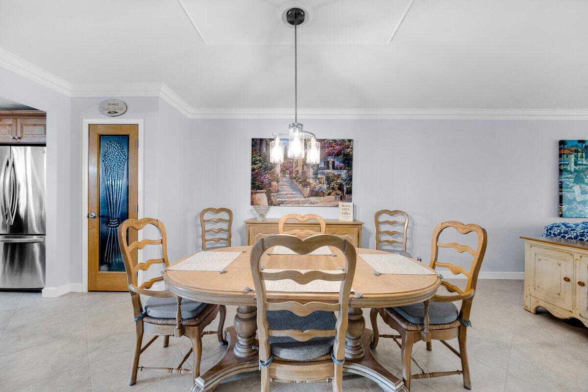 300 North Hwy A1A, Unit 104O Jupiter, FL 33477 - Photo 9 of 25 a dining room with furniture and window