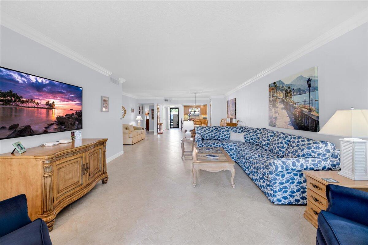 300 North Hwy A1A, Unit 104O Jupiter, FL 33477 - Photo 10 of 25 a living room with furniture and a flat screen tv