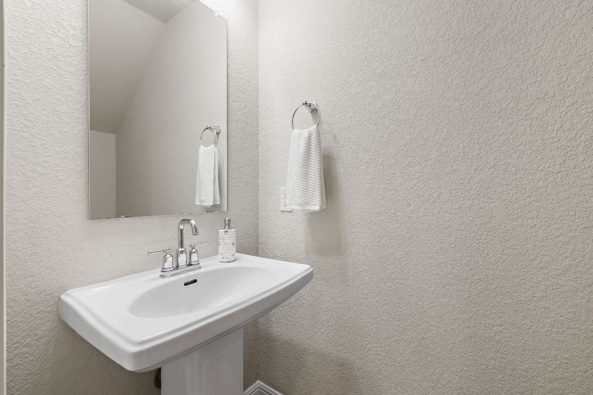9015 Cattle Baron Path, Unit 504 Austin, TX 78747 - Photo 13 of 36 a bathroom with a sink and a mirror