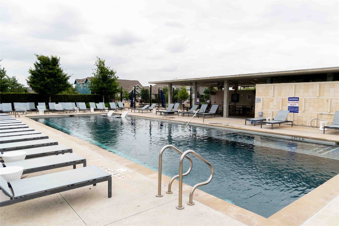 9015 Cattle Baron Path, Unit 504 Austin, TX 78747 - Photo 17 of 36 a swimming pool view with a outdoor seating space