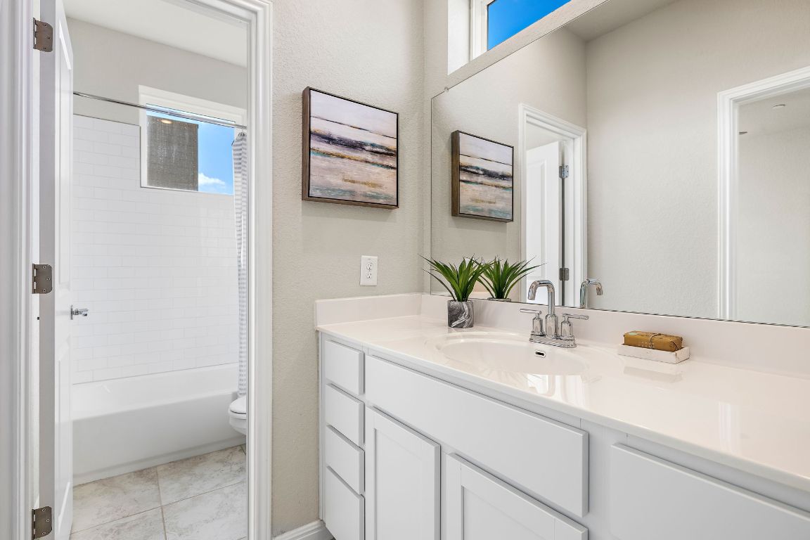 9015 Cattle Baron Path, Unit 504 Austin, TX 78747 - Photo 21 of 36 a bathroom with a sink and a mirror