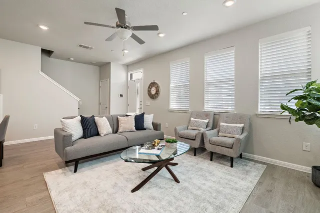 a living room with furniture and a large window