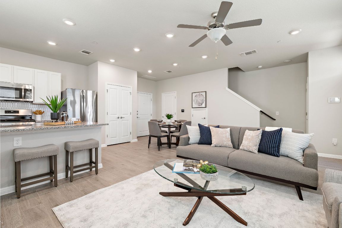 9015 Cattle Baron Path, Unit 504 Austin, TX 78747 - Photo 7 of 36 a living room with furniture and kitchen view