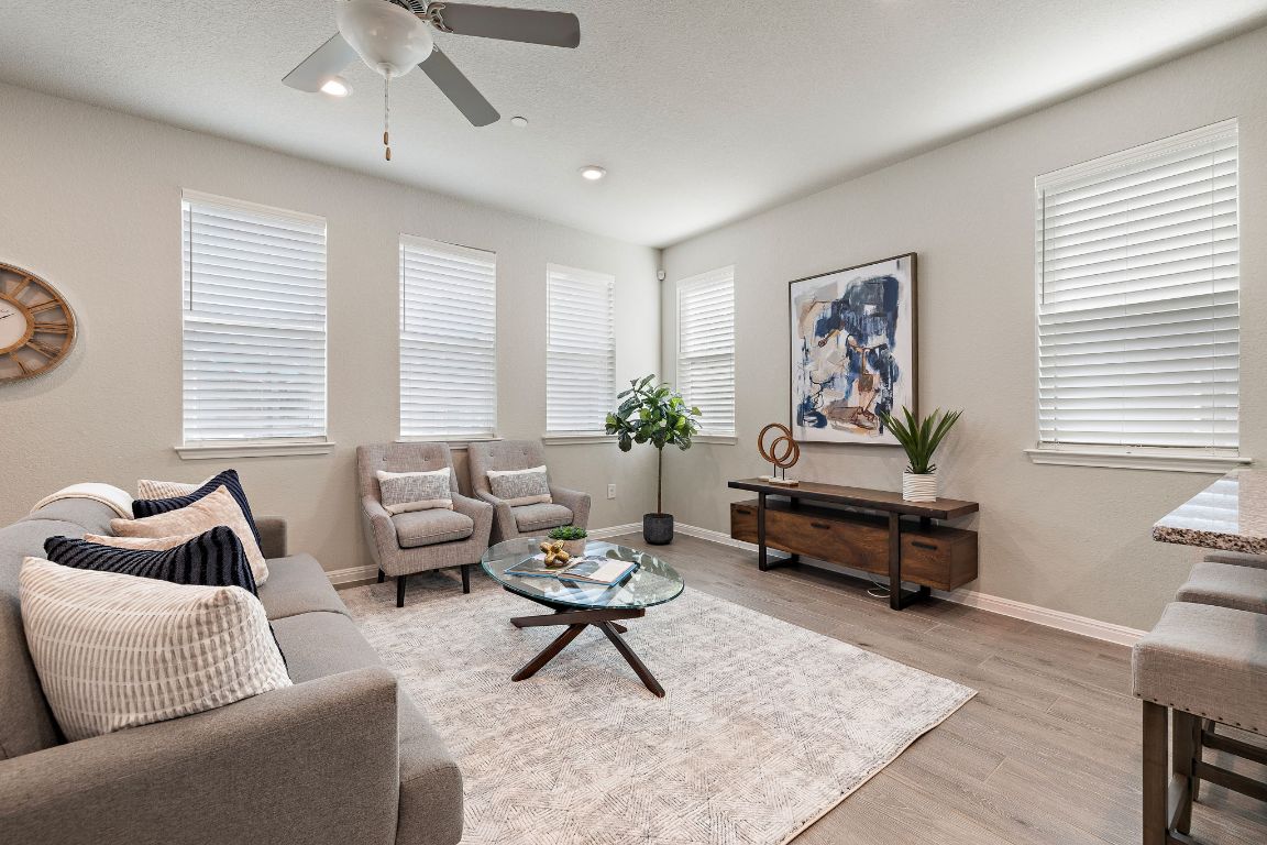 9015 Cattle Baron Path, Unit 504 Austin, TX 78747 - Photo 9 of 36 a living room with furniture and wooden floor