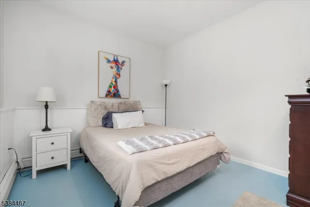 a bedroom with a bed and a night stand