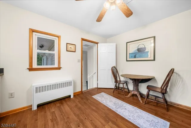 a view of a workspace with furniture and wooden floor