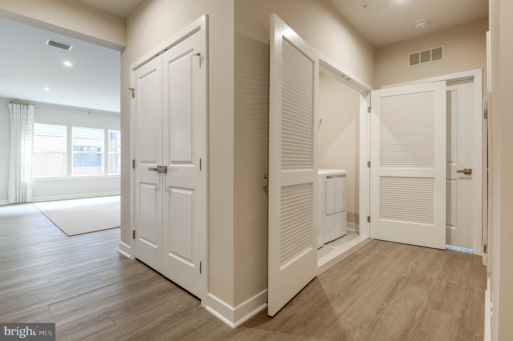4395 Peach Lily Lane, Unit 304 Chantilly, VA 20151 - Photo 26 of 36 a view of a hallway with wooden floor and cabinet