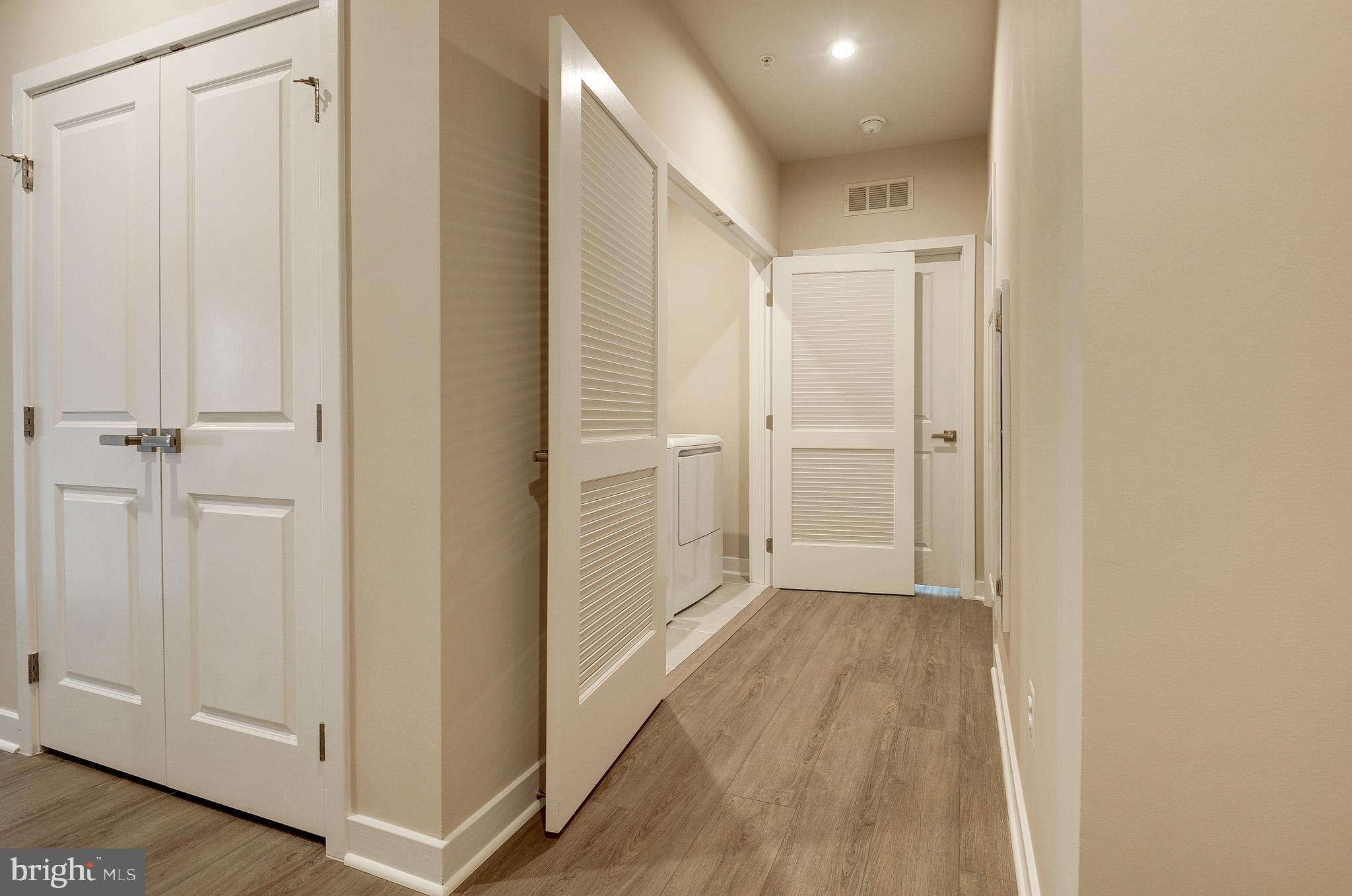 4395 Peach Lily Lane, Unit 304 Chantilly, VA 20151 - Photo 27 of 36 a view of a hallway with wooden floor