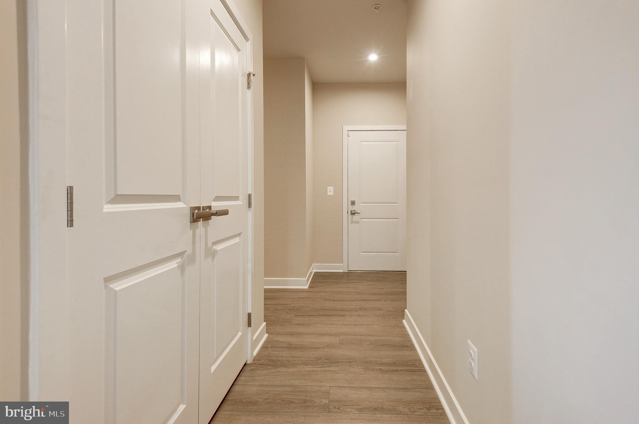 4395 Peach Lily Lane, Unit 304 Chantilly, VA 20151 - Photo 28 of 36 a view of a hallway with wooden floor