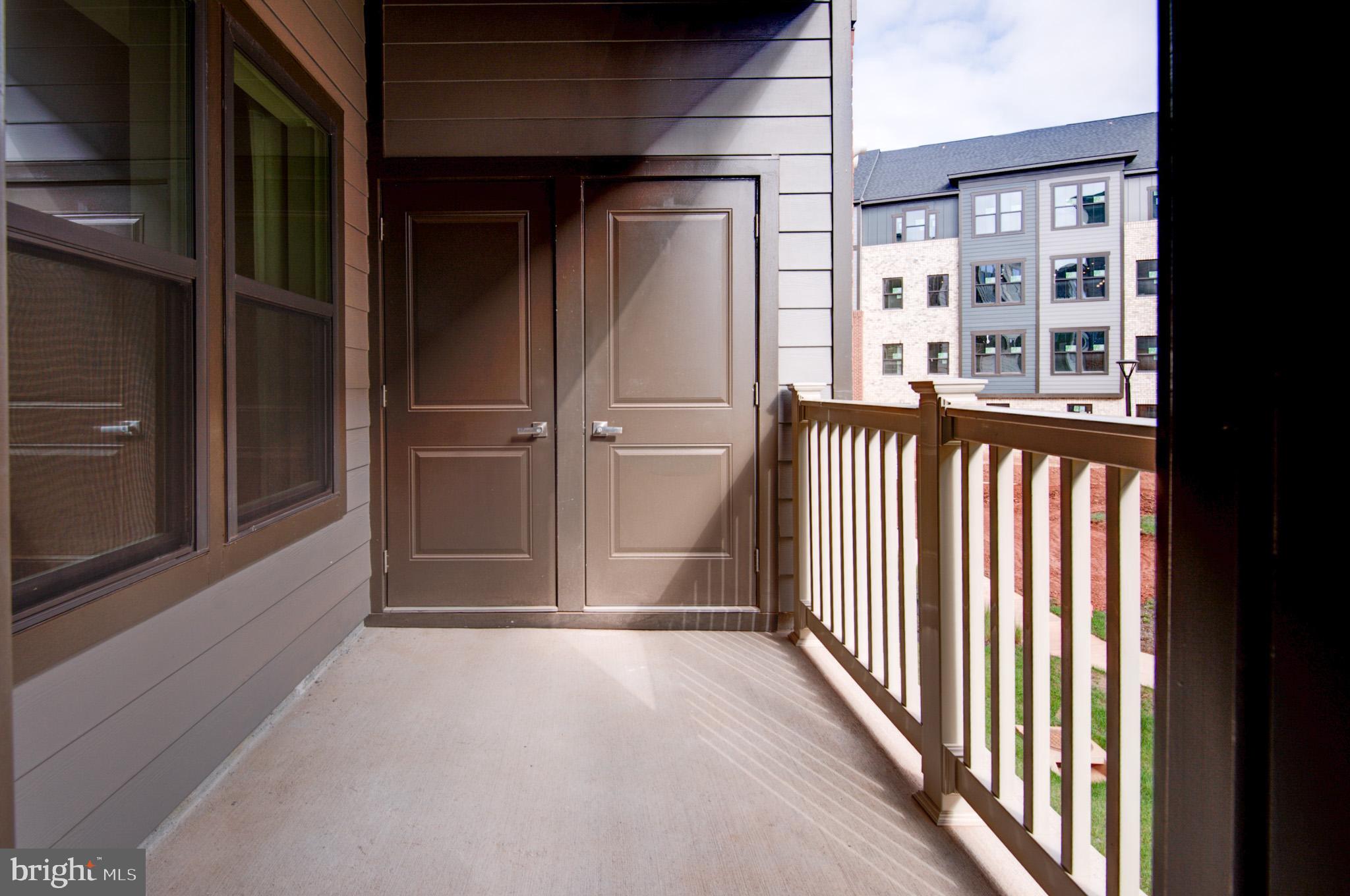 4395 Peach Lily Lane, Unit 304 Chantilly, VA 20151 - Photo 29 of 36 a view of a porch with wooden floor