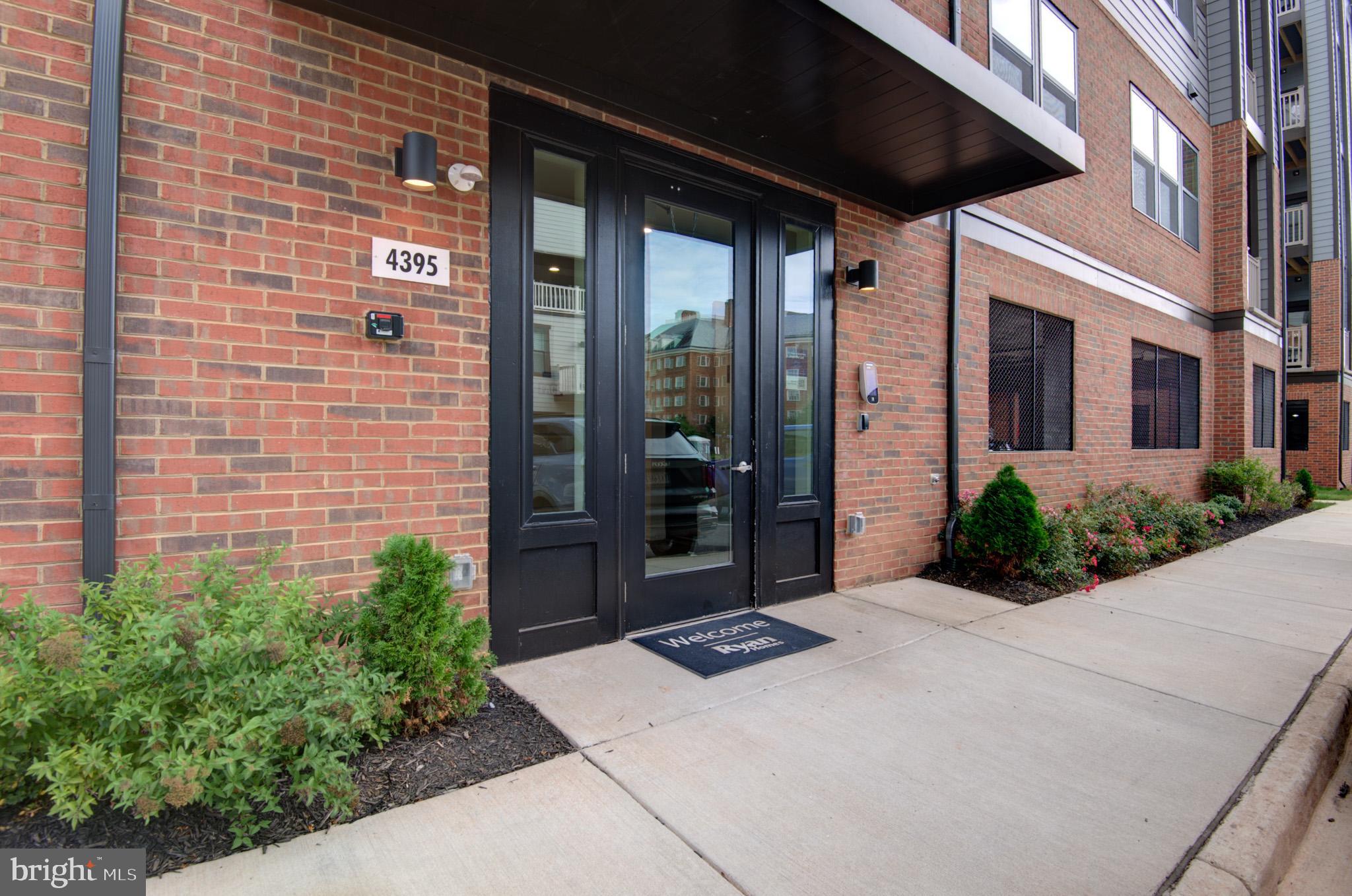 4395 Peach Lily Lane, Unit 304 Chantilly, VA 20151 - Photo 31 of 36 a view of a brick house with potted plants