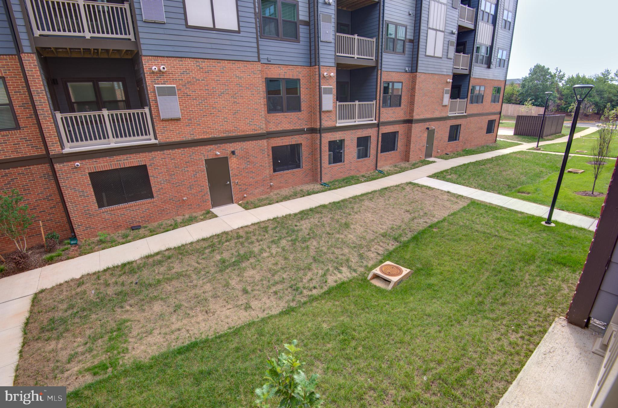 4395 Peach Lily Lane, Unit 304 Chantilly, VA 20151 - Photo 35 of 36 front view of a building with a yard