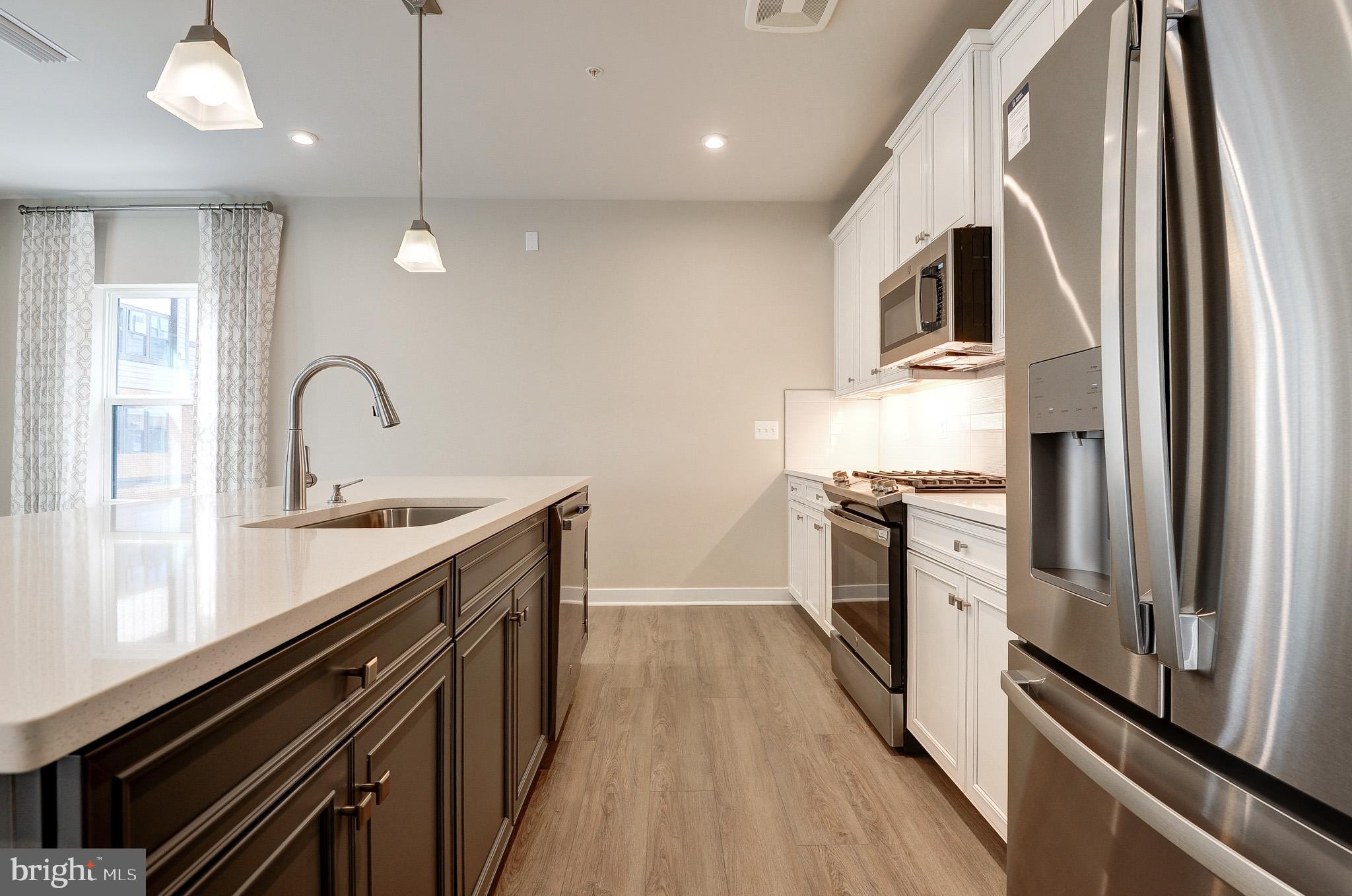 4395 Peach Lily Lane, Unit 304 Chantilly, VA 20151 - Photo 6 of 36 a kitchen with stainless steel appliances granite countertop a sink and a stove
