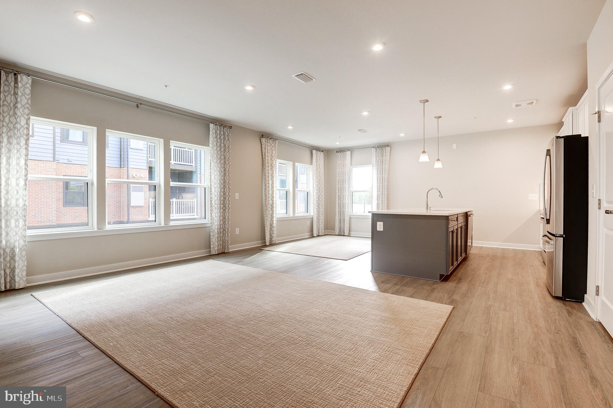 4395 Peach Lily Lane, Unit 304 Chantilly, VA 20151 - Photo 8 of 36 a view of an empty room with a window and wooden floor