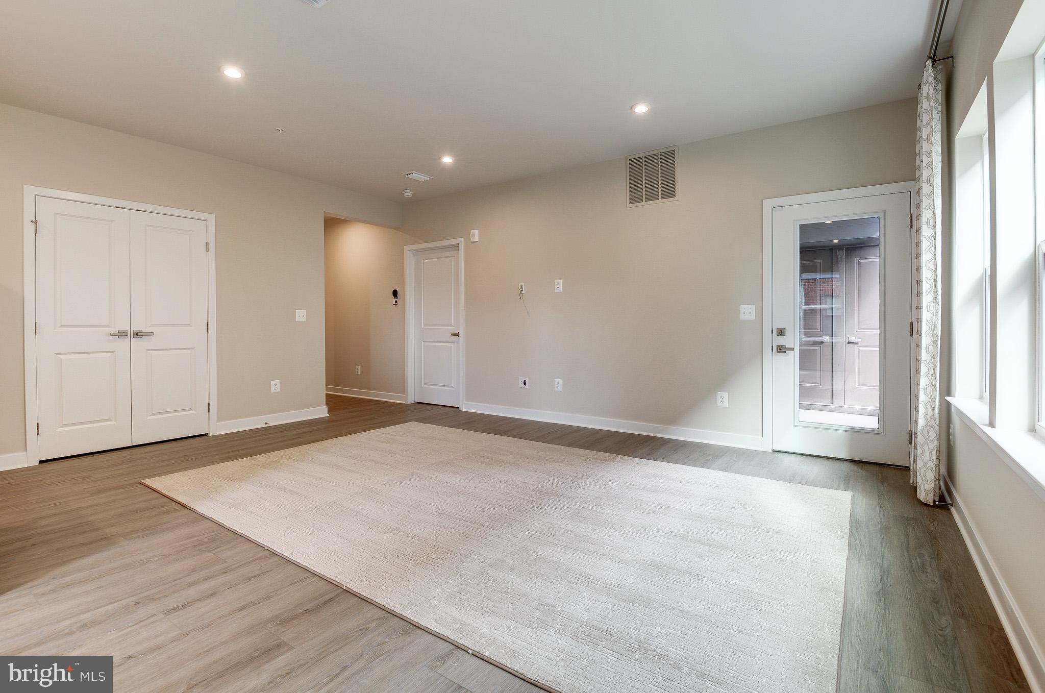 4395 Peach Lily Lane, Unit 304 Chantilly, VA 20151 - Photo 10 of 36 an empty room with wooden floor and windows