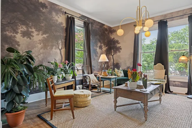 a living room filled with furniture and a chandelier