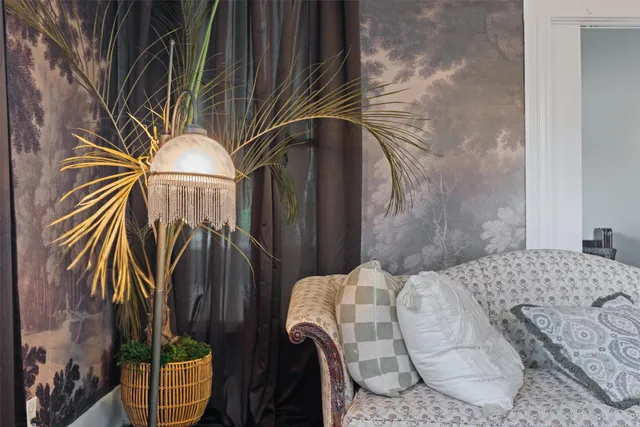 a bedroom with bed and a painting on the wall