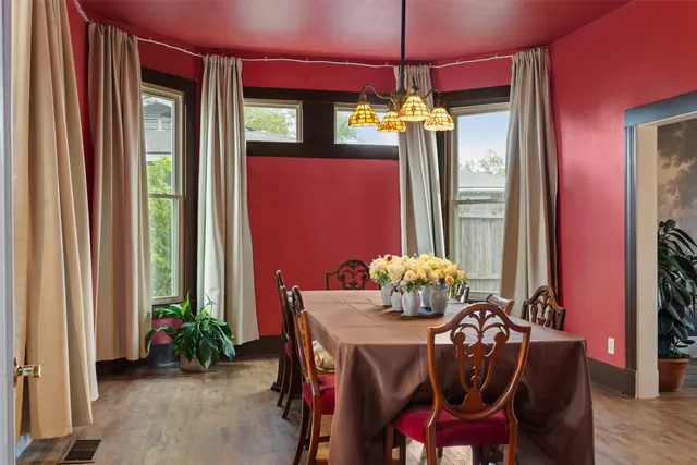 a dining room with furniture a chandelier and window