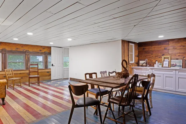 a living room with furniture a rug and a table