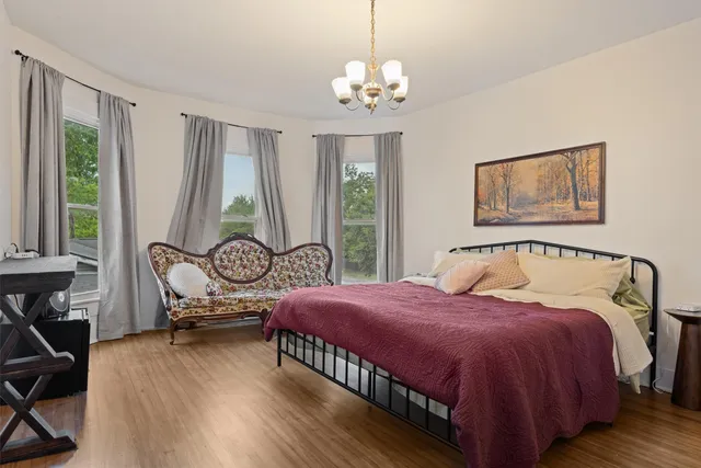 a bedroom with a bed and a window