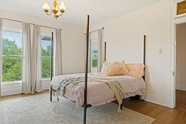 a bedroom with a bed and a mirror