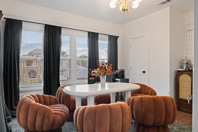 a dining room with furniture and a chandelier