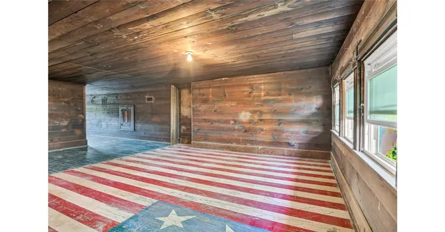 a room with a balcony and a rug