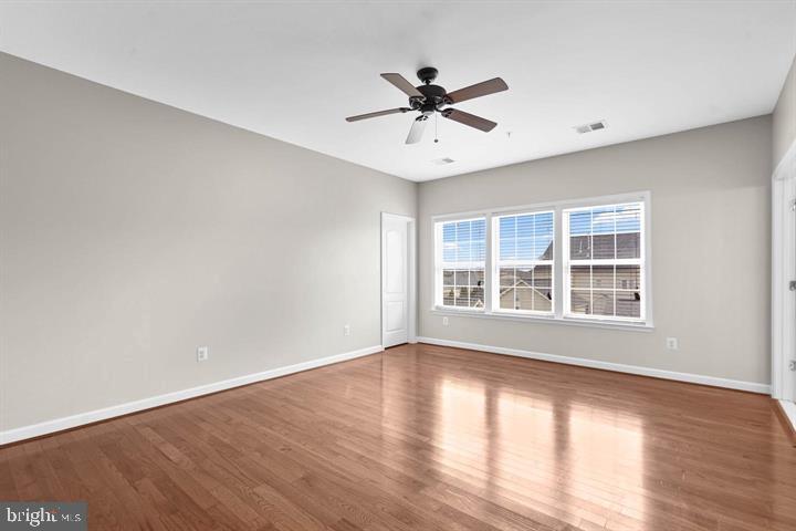 23215 Frederick Road Clarksburg, MD 20871 - Photo 14 of 31 a view of an empty room with wooden floor and a window