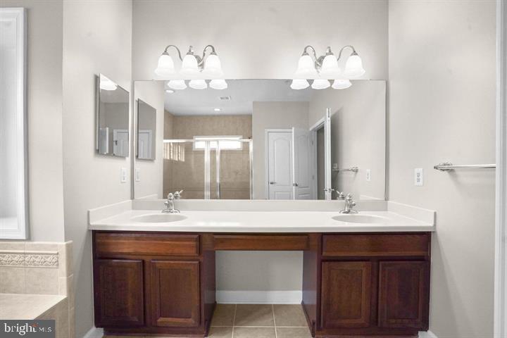 23215 Frederick Road Clarksburg, MD 20871 - Photo 16 of 31 a bathroom with a sink double vanity and a mirror