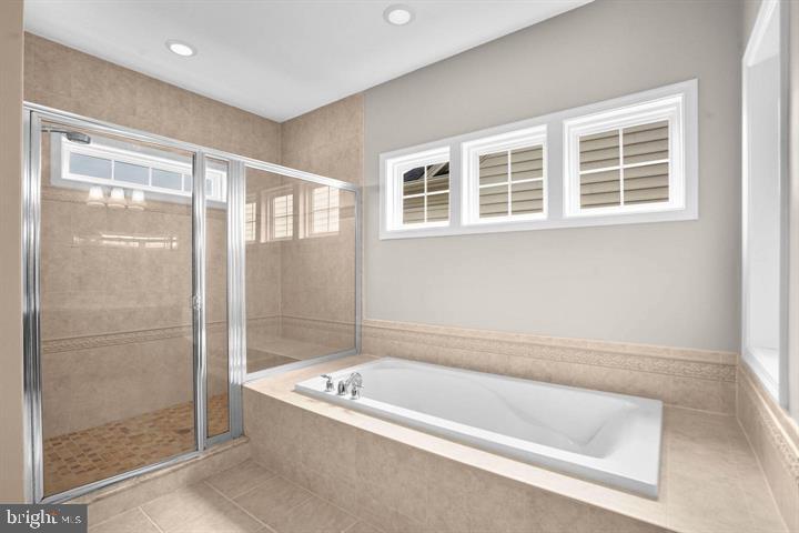 23215 Frederick Road Clarksburg, MD 20871 - Photo 17 of 31 a bathroom with a bathtub and a shower